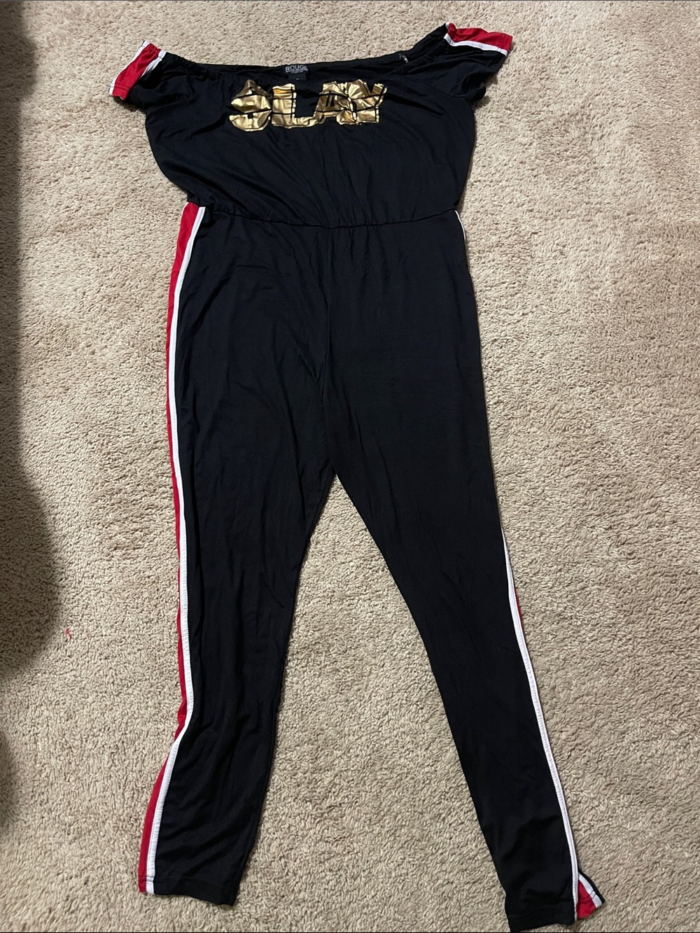 Black Off-Shoulder Jumpsuit with Gold Logo and Red Trim